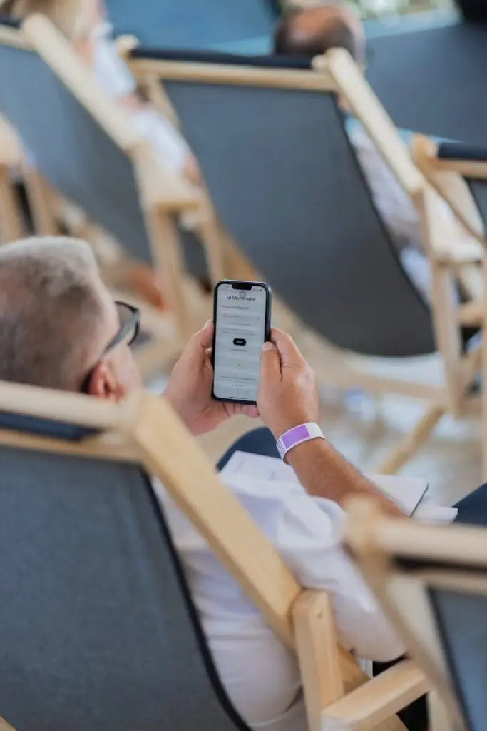 man-on-a-deckchair-browsing-the-website-on-his-phone-27220245 man-on-a-deckchair-browsing-the-website-on-his-phone-27220245